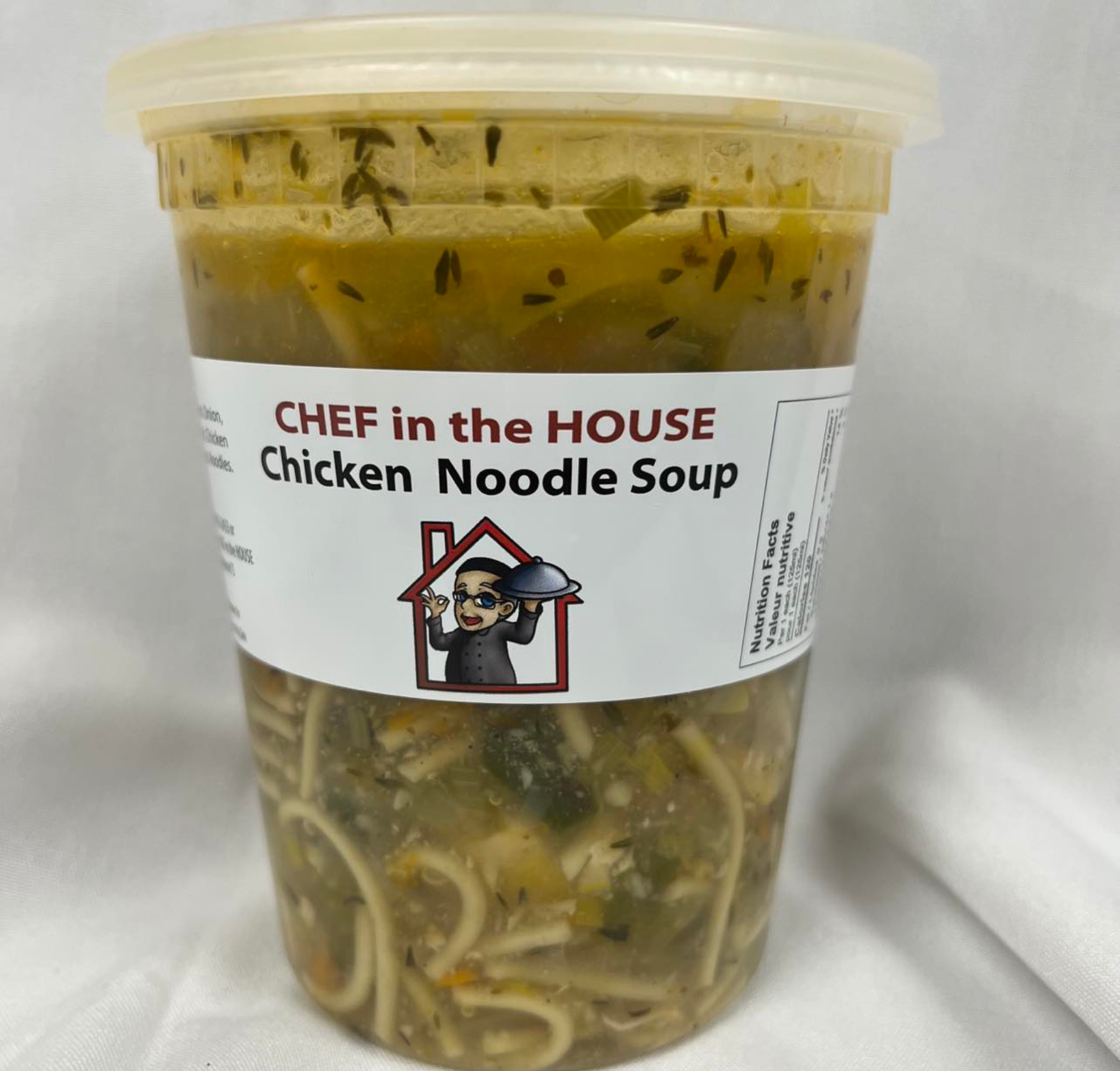 A bowl of Chicken Noodle Soup with visible chunks of chicken, noodles, and vegetables like carrots and onions.