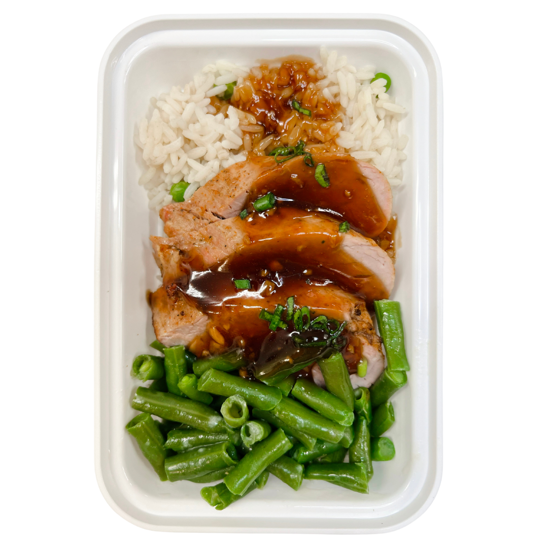 Oven-roasted Pork Tenderloin glazed with a homemade gingery honey garlic sauce. Served with rice pilaf and green beans.
