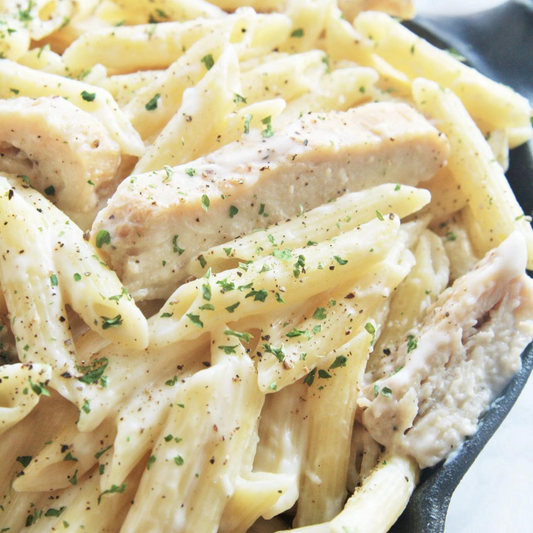 Penne Noodles and tender strips of oven-baked chicken breast tossed in a creamy garlic alfredo sauce.