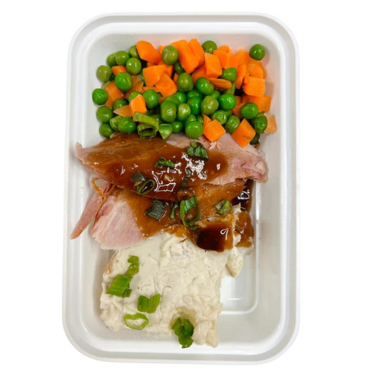 Baked Ham glazed with a homemade honey mustard sauce and creamy scalloped potatoes. Served with green peas.