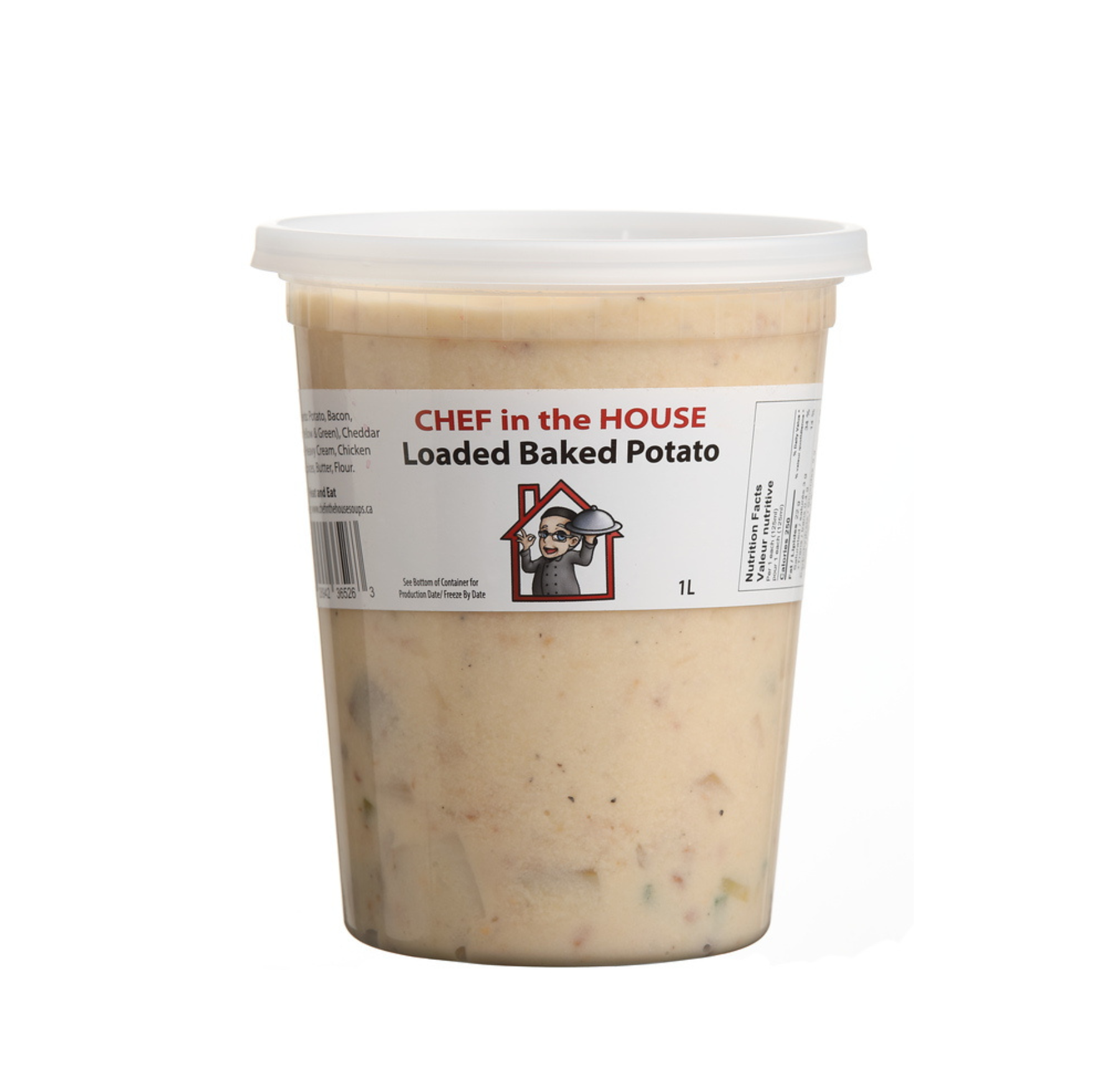 A bowl of baked potato soup garnished with bacon, cheese, and green onions, with ingredients and a napkin in the background.