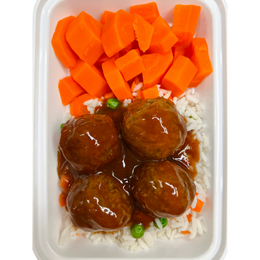Container of sweet and sour meatballs with gravy, rice, and carrots 